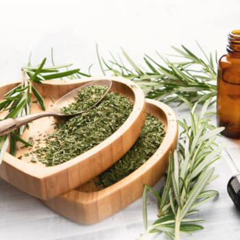 Ounces of rosemary being displayed on a spoon